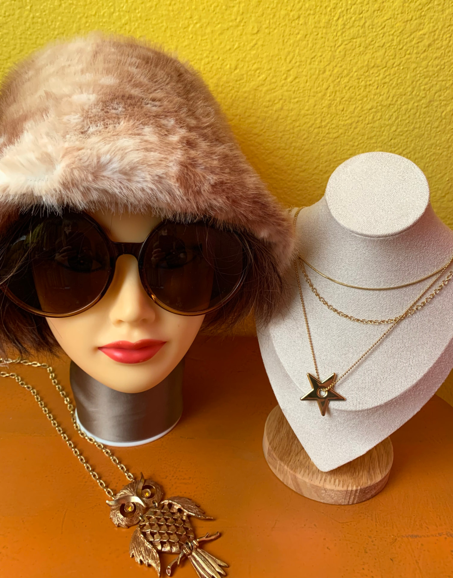 Faux fur bucket hat, oversized sunglasses, and gold necklaces
