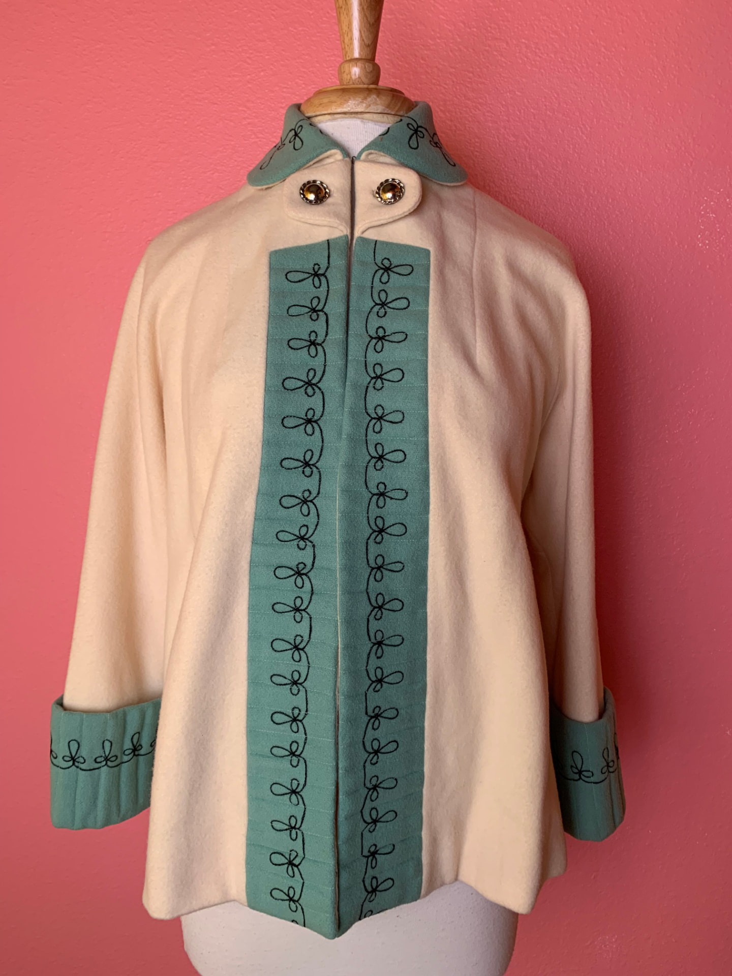 Cream wool swing coat with green embroidered trim