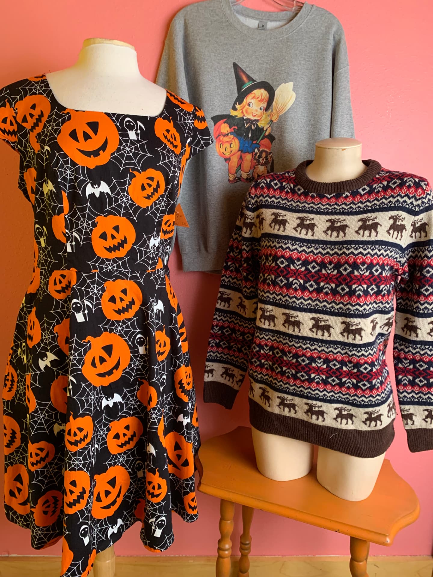 Jack-o'-lantern dress, vintage witch sweatshirt, and reindeer sweater