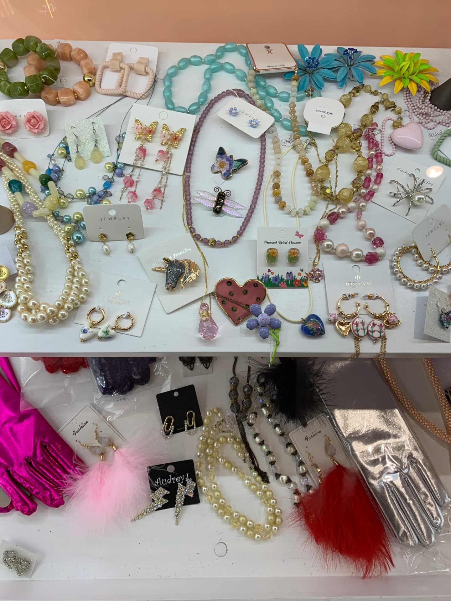 Display of colorful jewelry, earrings, brooches, and gloves