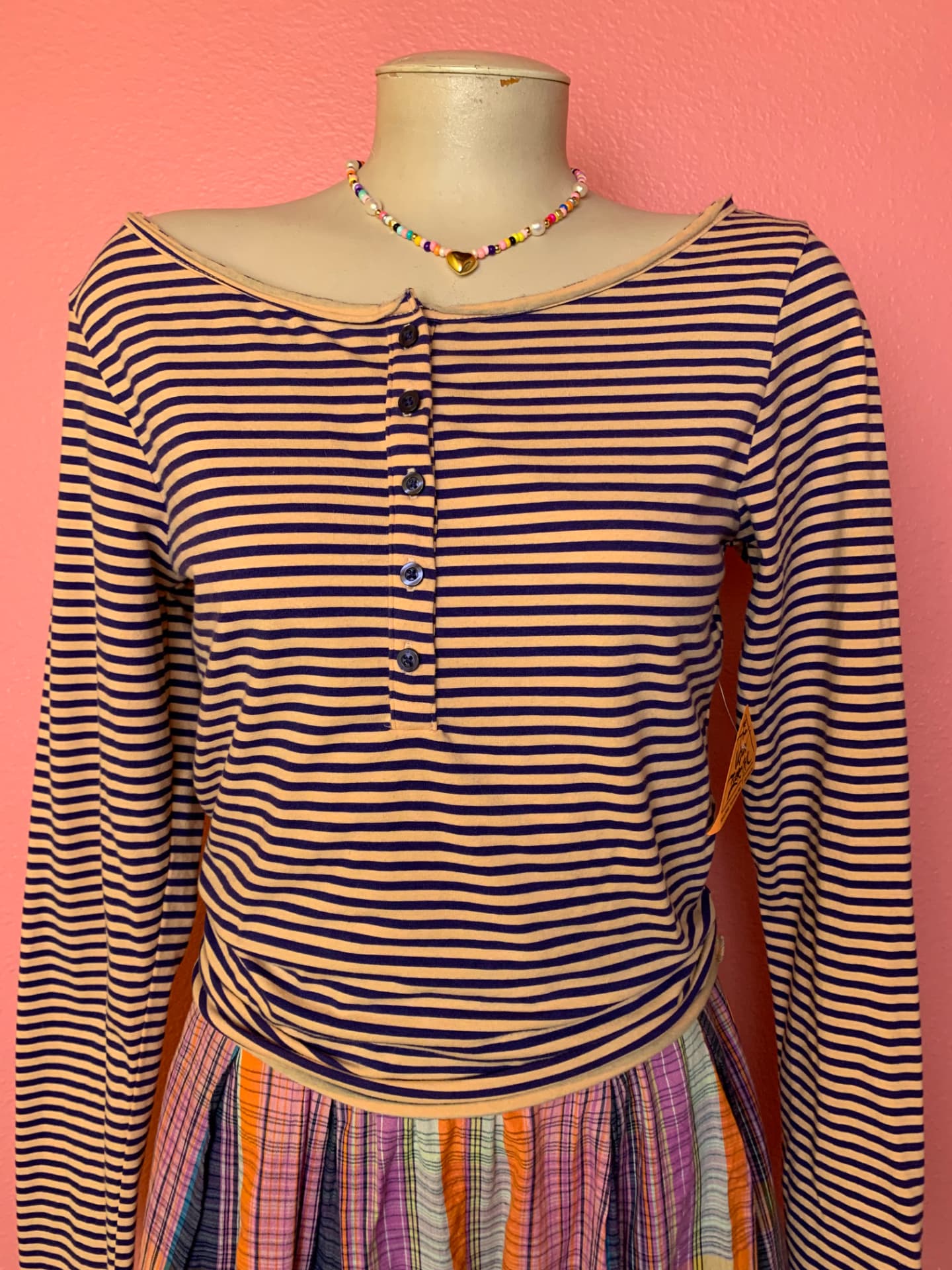 Peach and navy striped henley with a beaded heart necklace